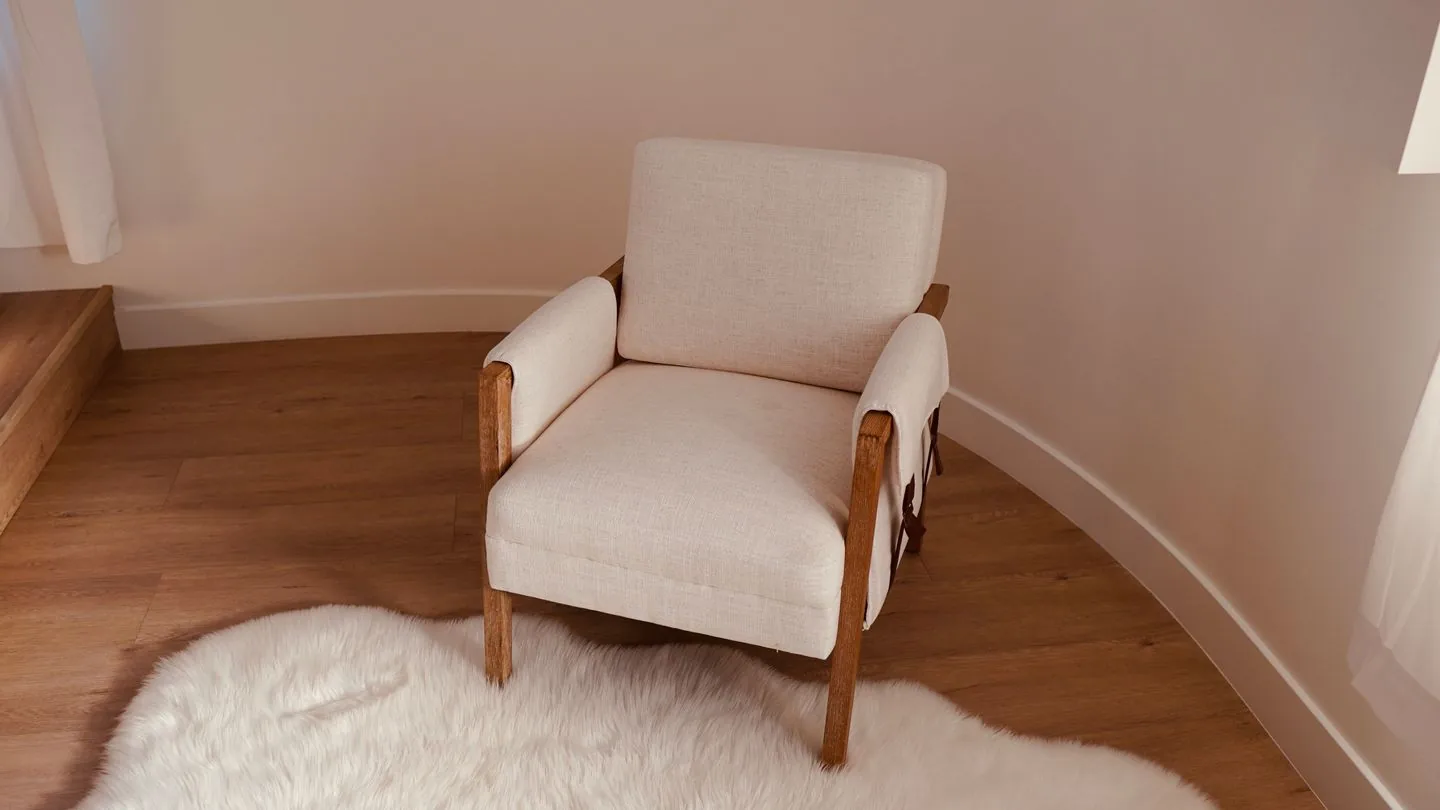 Compact upholstered armchair on a pale rug