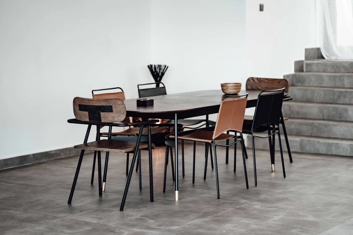 Dining table surrounded by mixed modern chairs