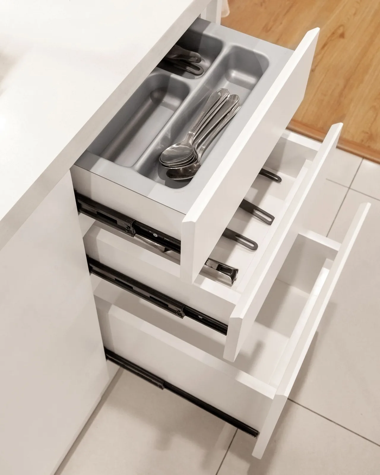 Open kitchen drawers with a cutlery organiser