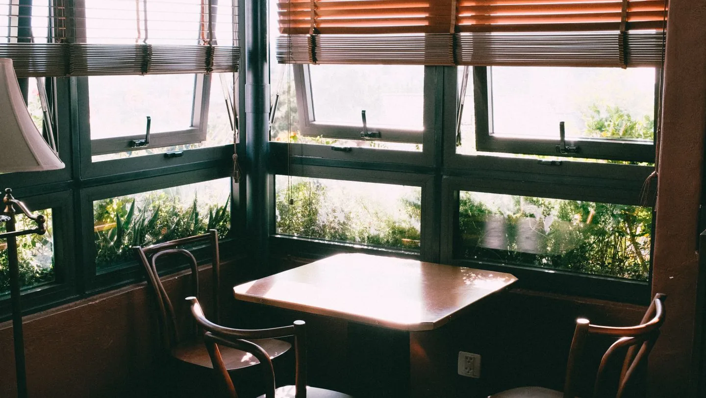 Small dining table for two beside a window