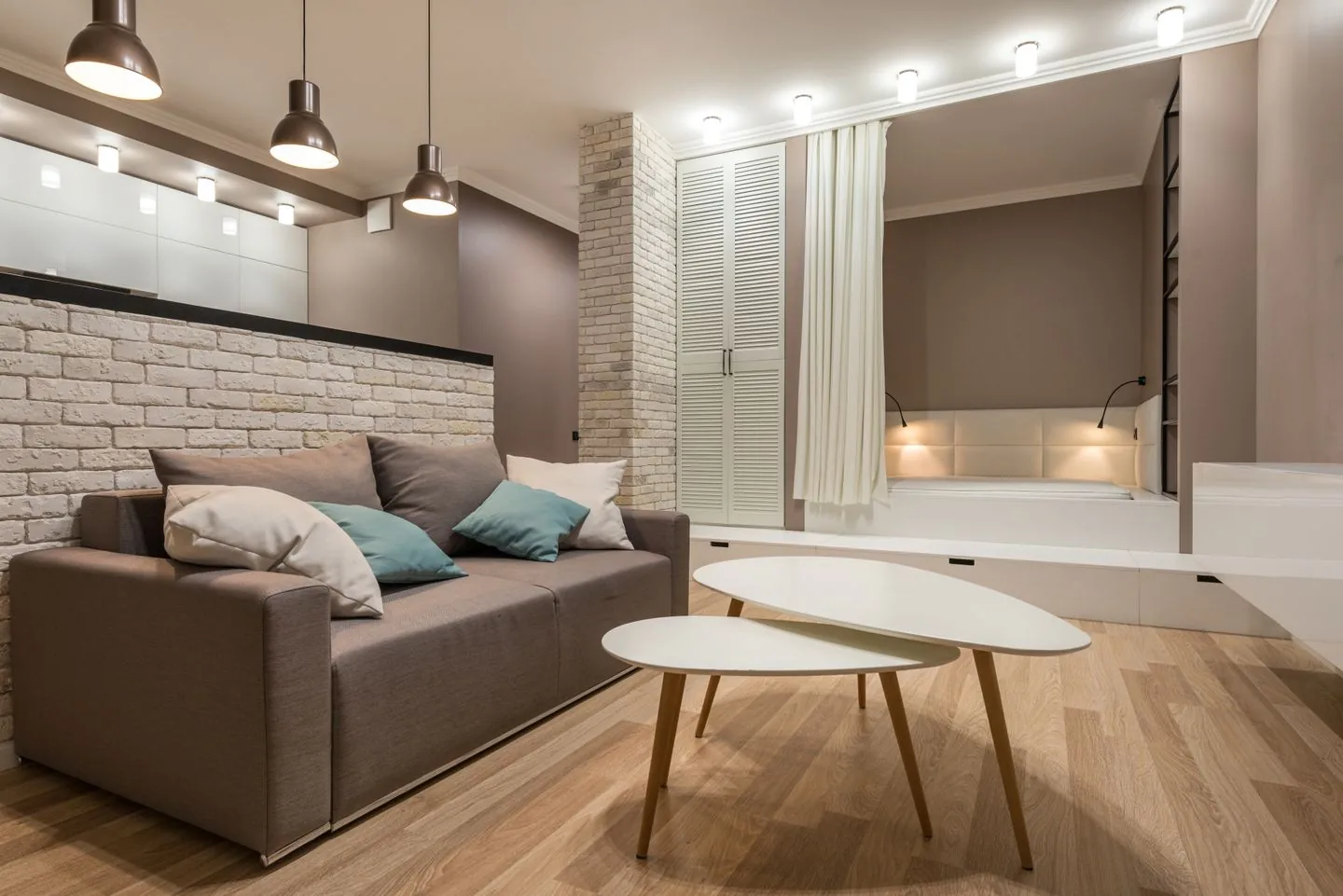 Grey sofa and nesting coffee tables with a clear walkway