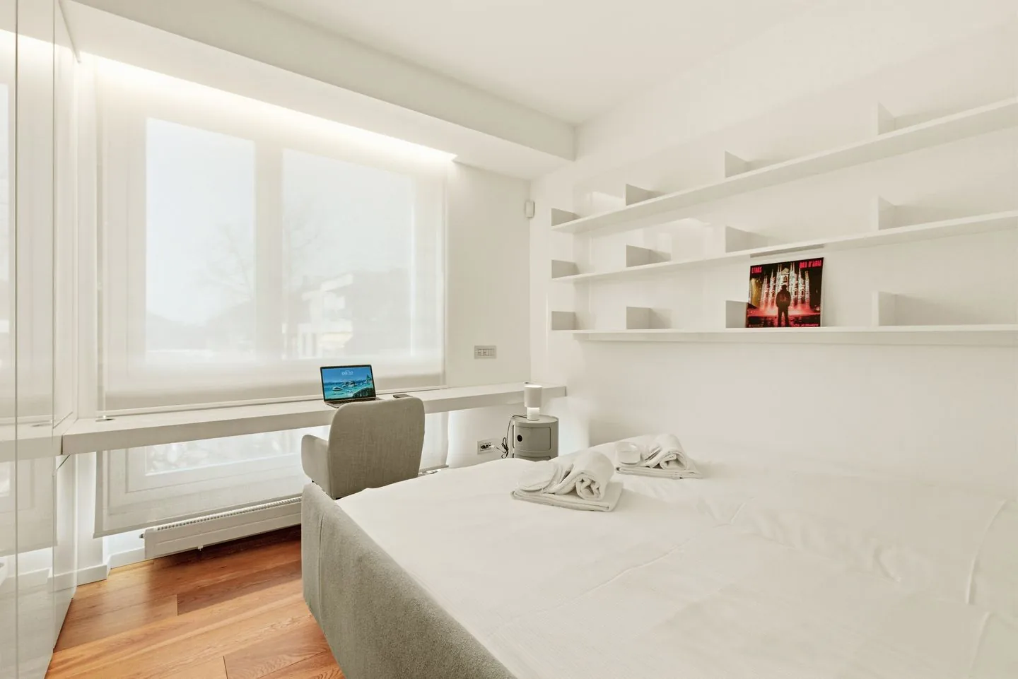 Bright bedroom with a desk beside the window