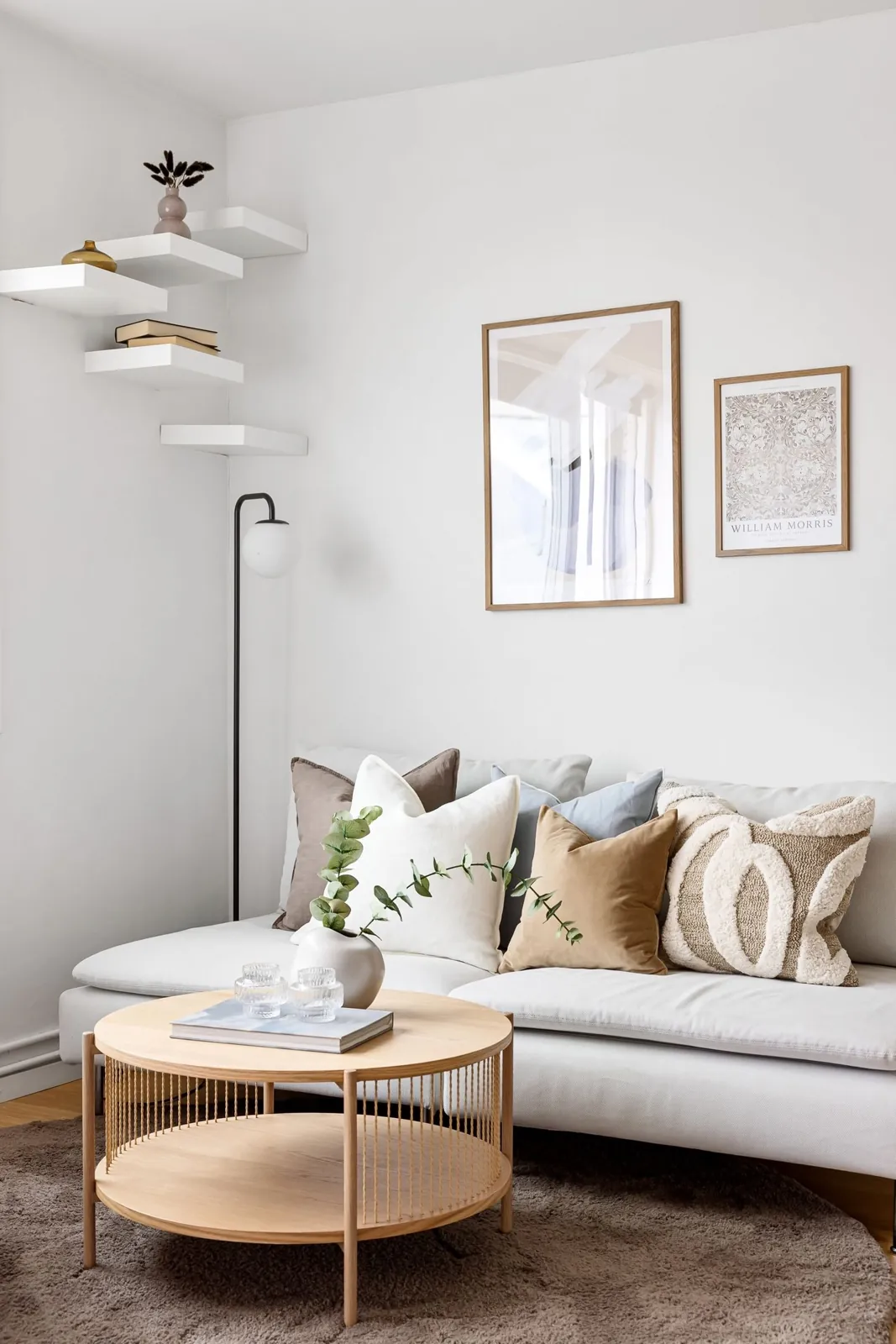 Tidy living room with pale seating and coffee tables
