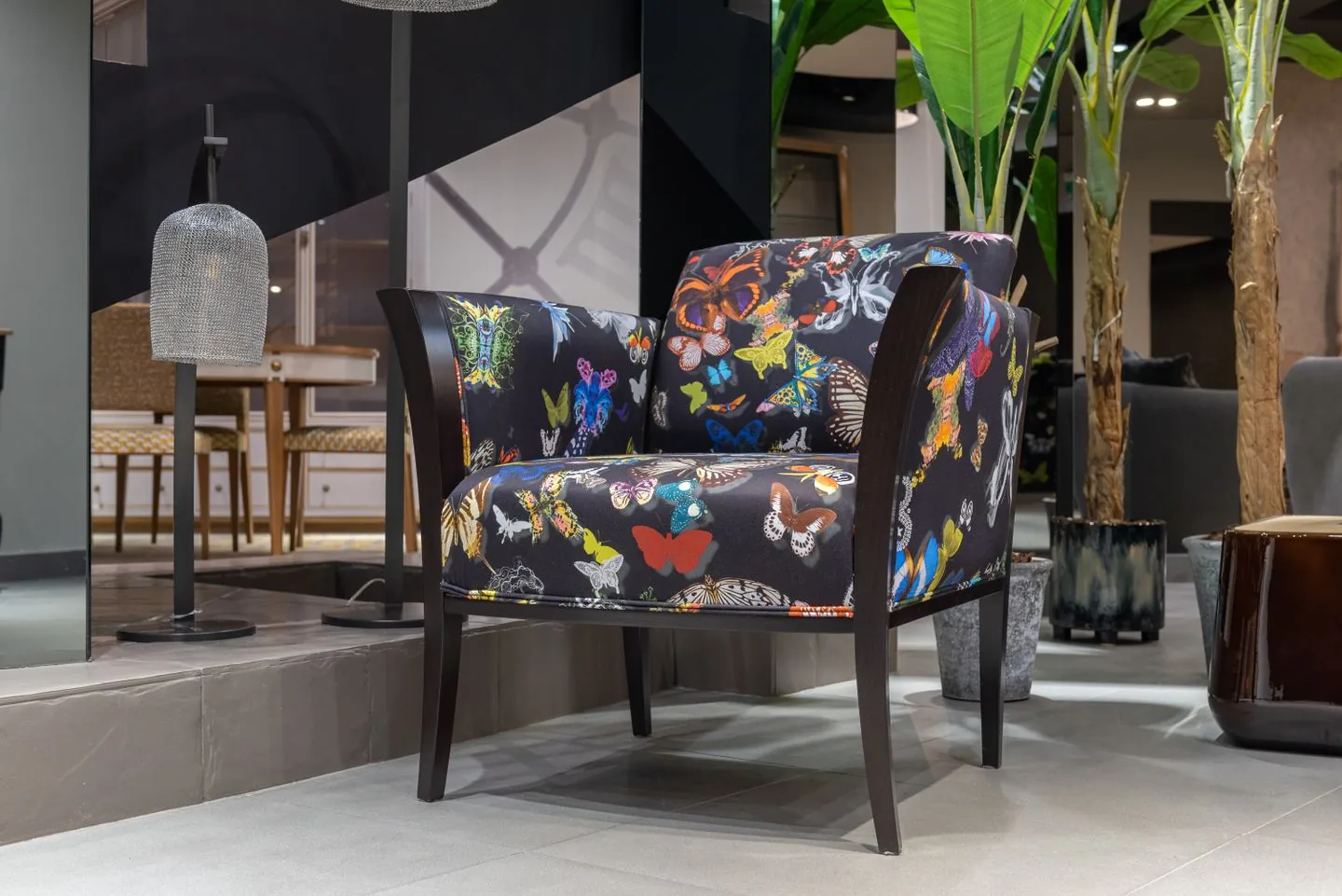 Patterned accent chair beside a small lamp