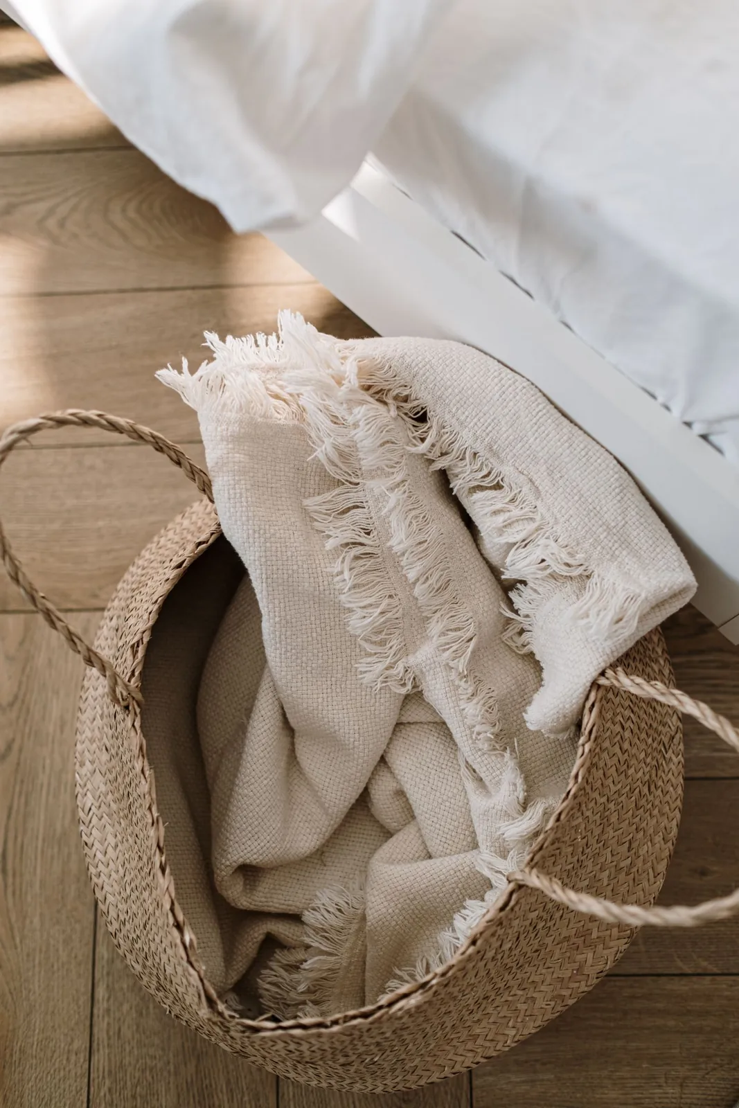 Textured throw draped over a woven basket