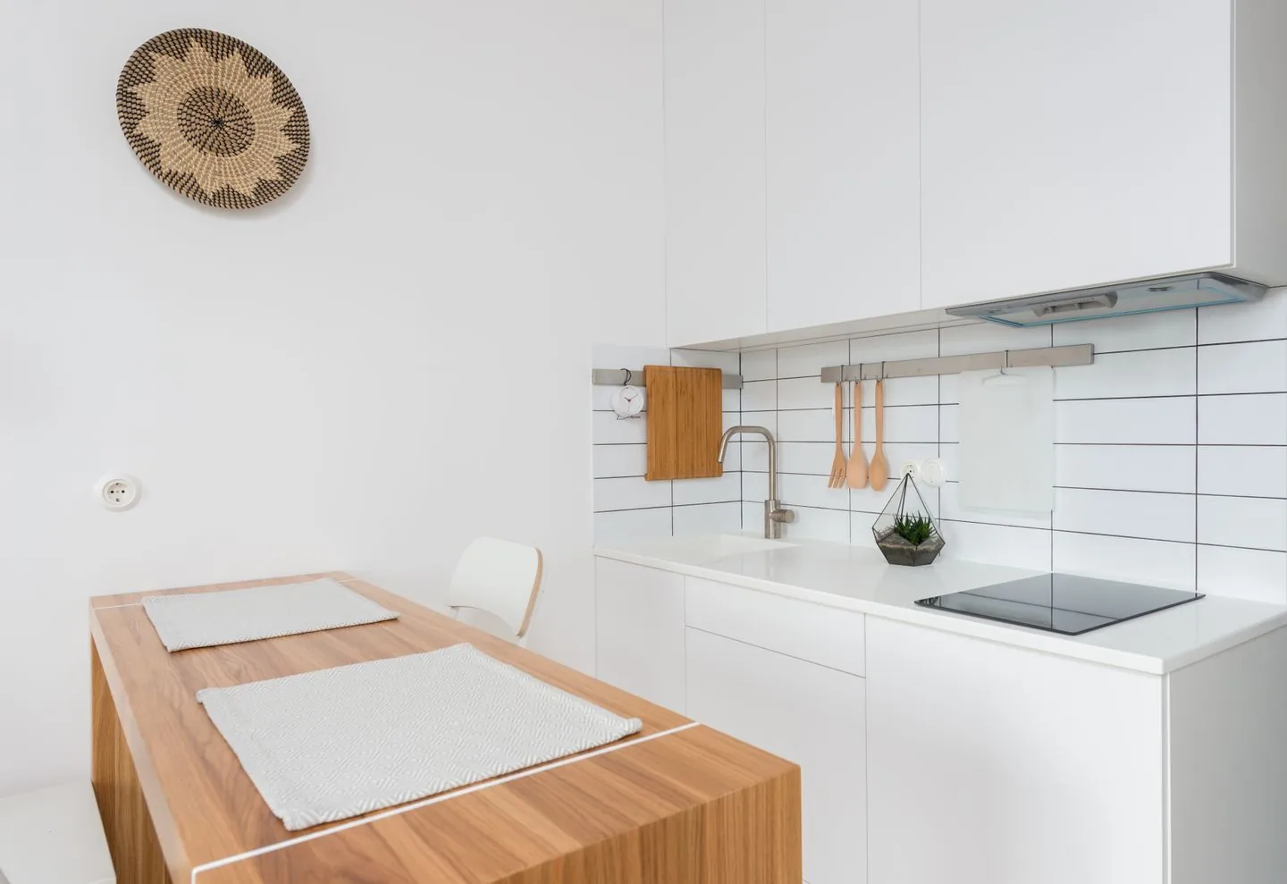 White kitchen with a wooden table and worktop