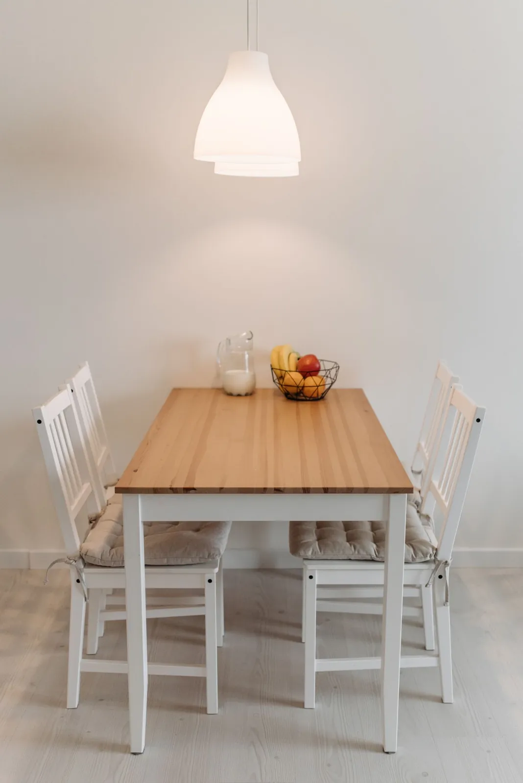 Pendant shade suspended above a small dining table