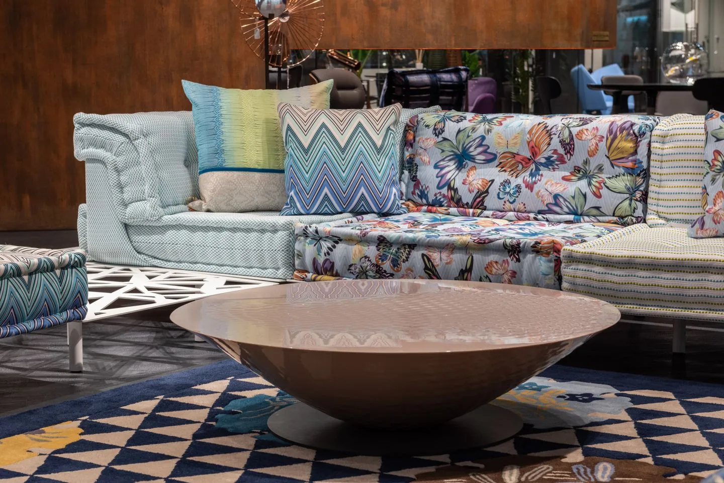 Sofa with patterned upholstery and layered cushions