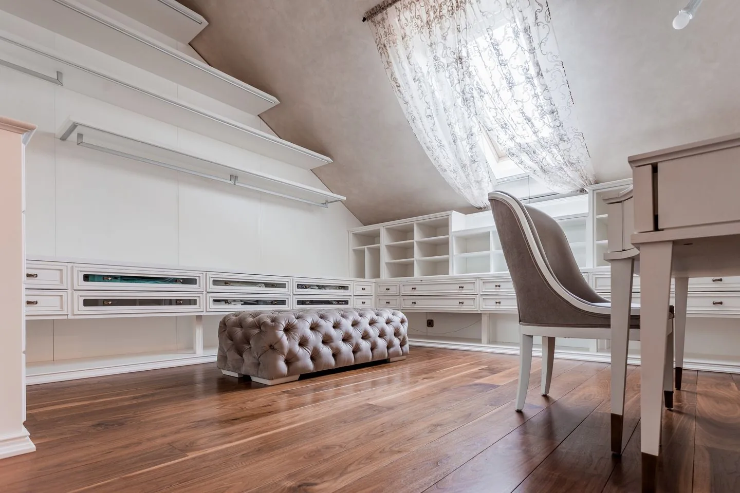 Desk and chair beneath an attic ceiling