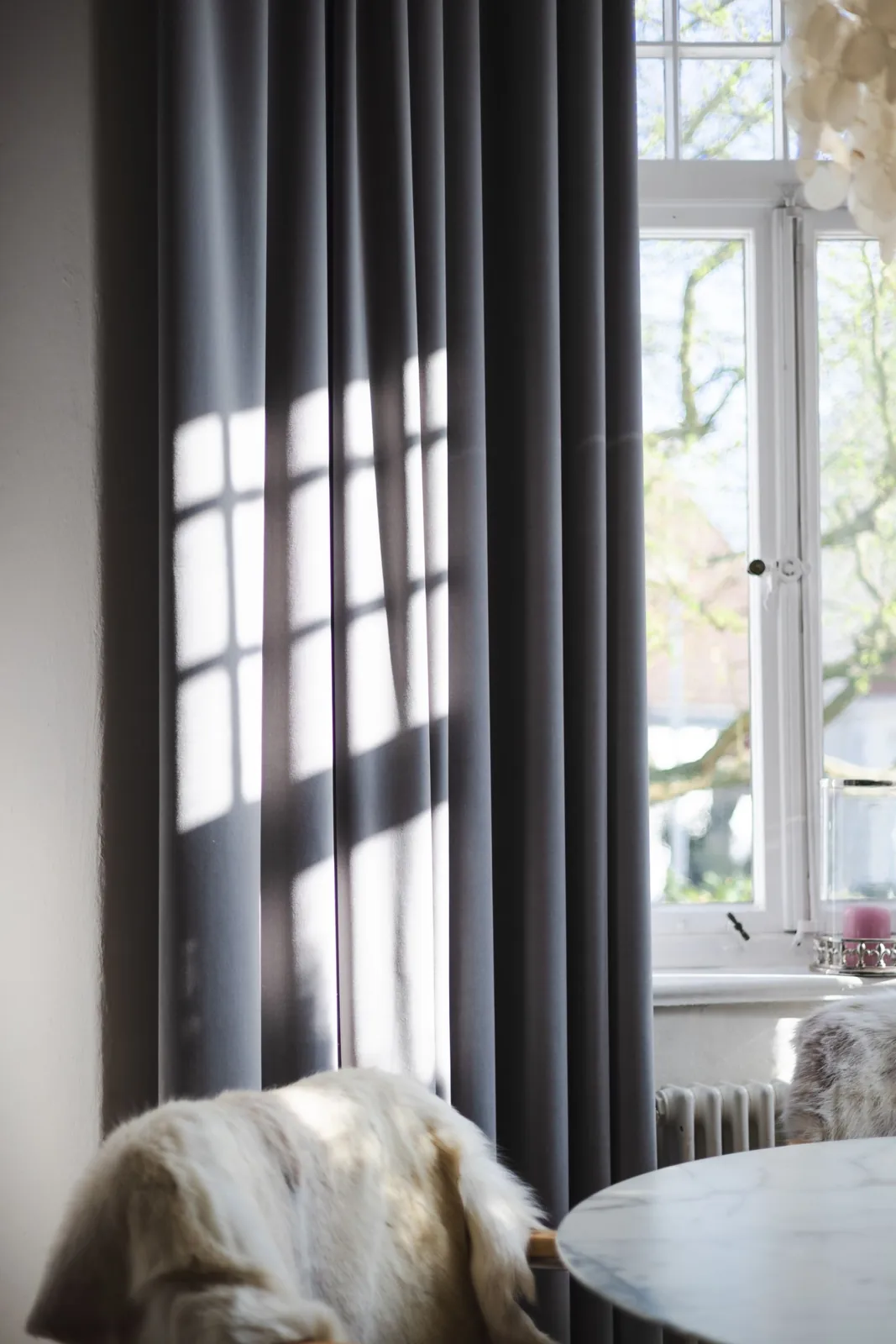 Tall curtains framing a bright living-room window