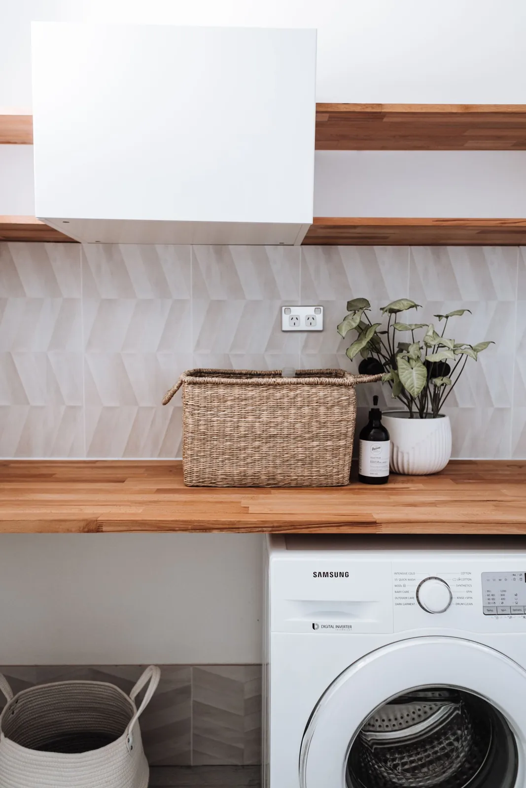 Washing machine beneath a worktop with baskets above