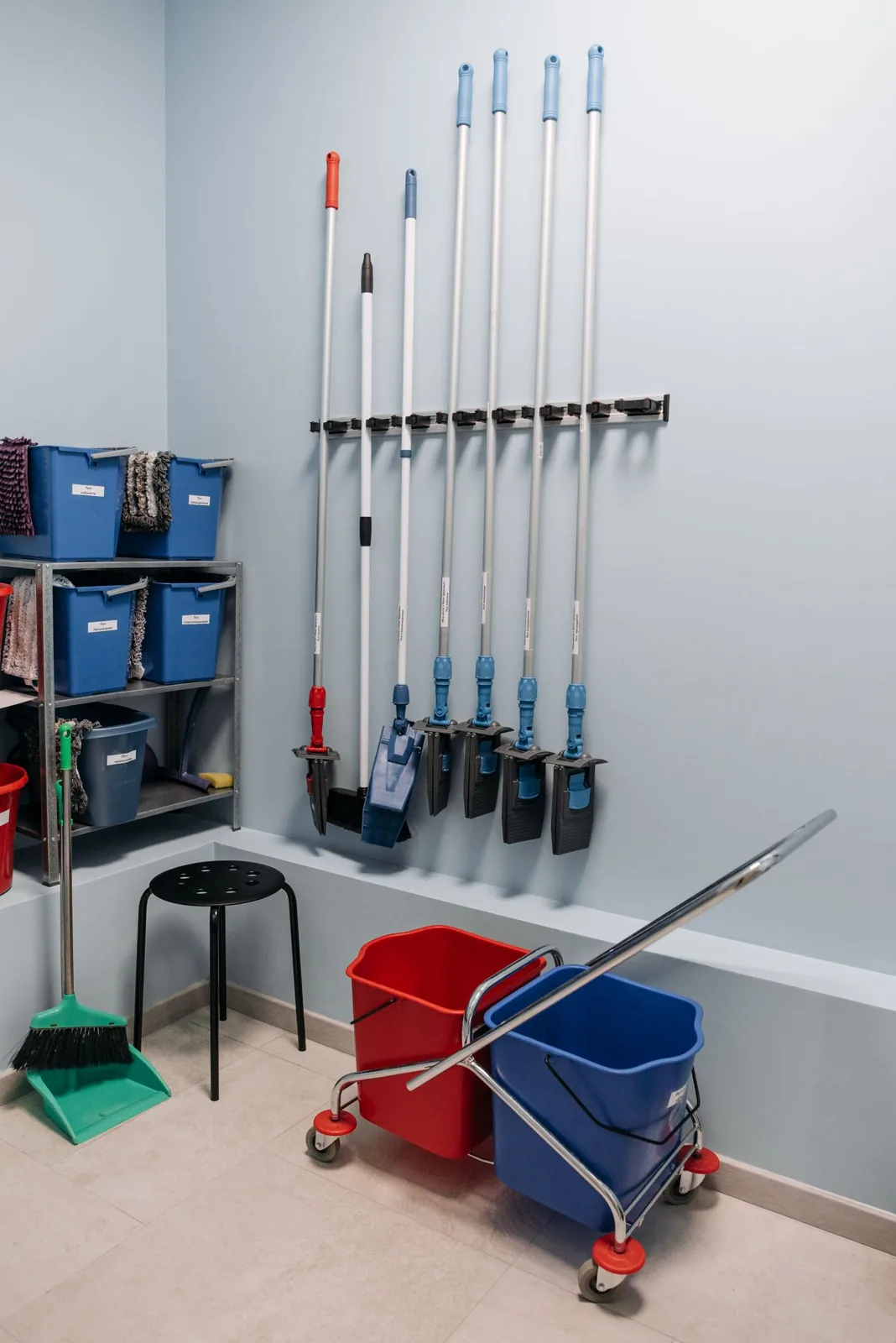 Mops, buckets and cleaning tools stored together