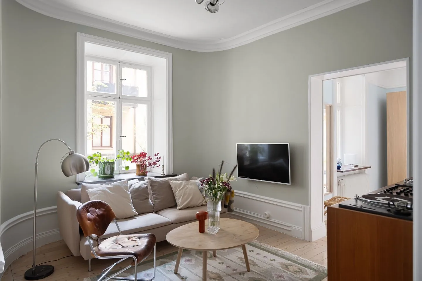 Small living room with a pale sofa and round table