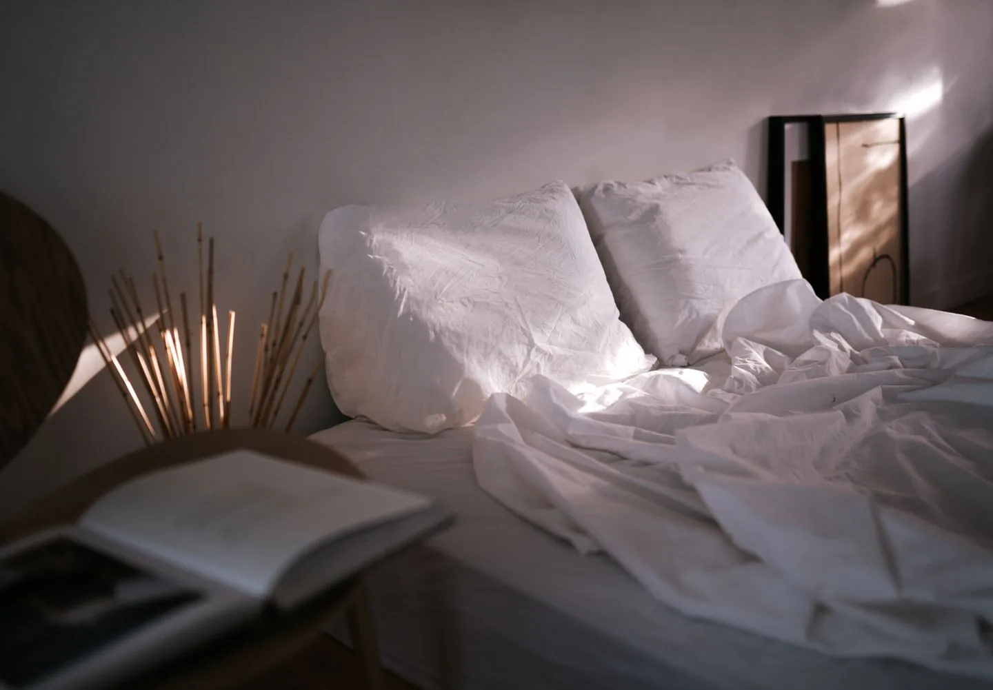 Pale bed linen catching daylight from a nearby window