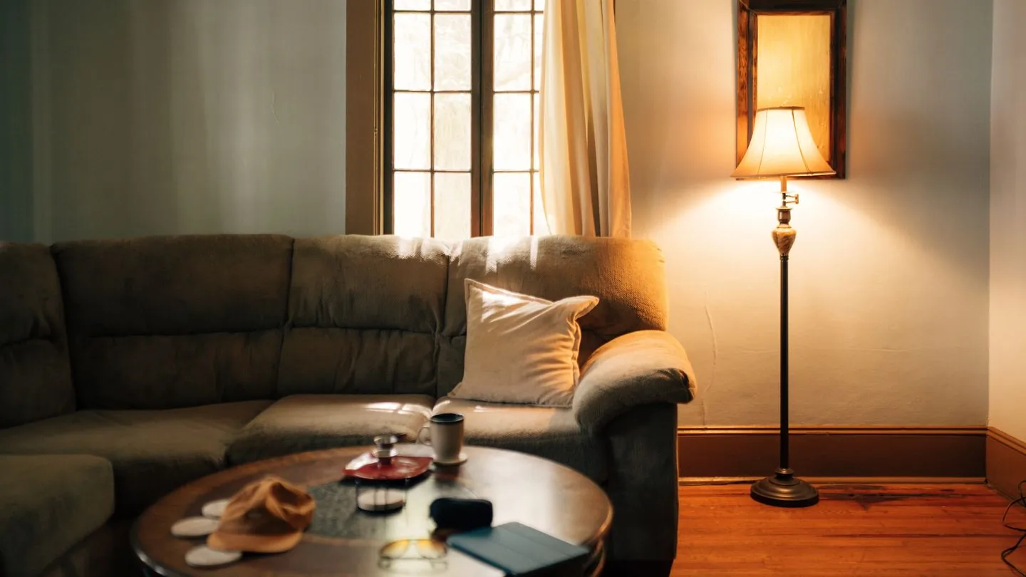 Sofa and floor lamp in a warmly lit room
