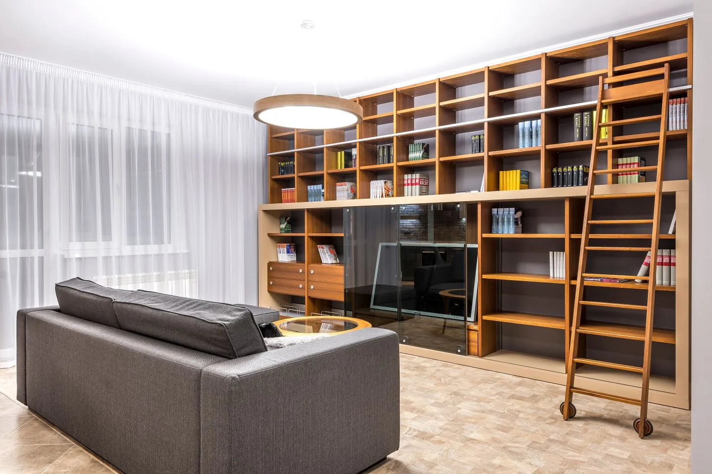 Full-height wooden shelving along a living-room wall