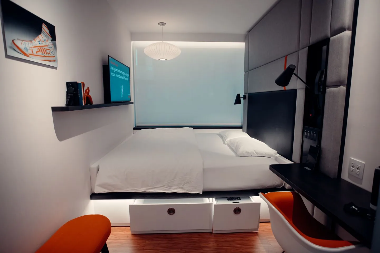 Bed with pull-out storage drawers beneath the mattress