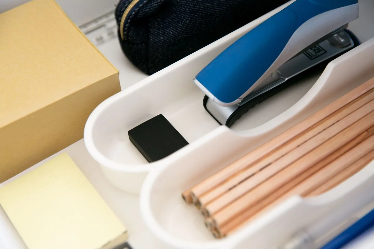 Pencils, sticky notes and a stapler in a drawer organiser
