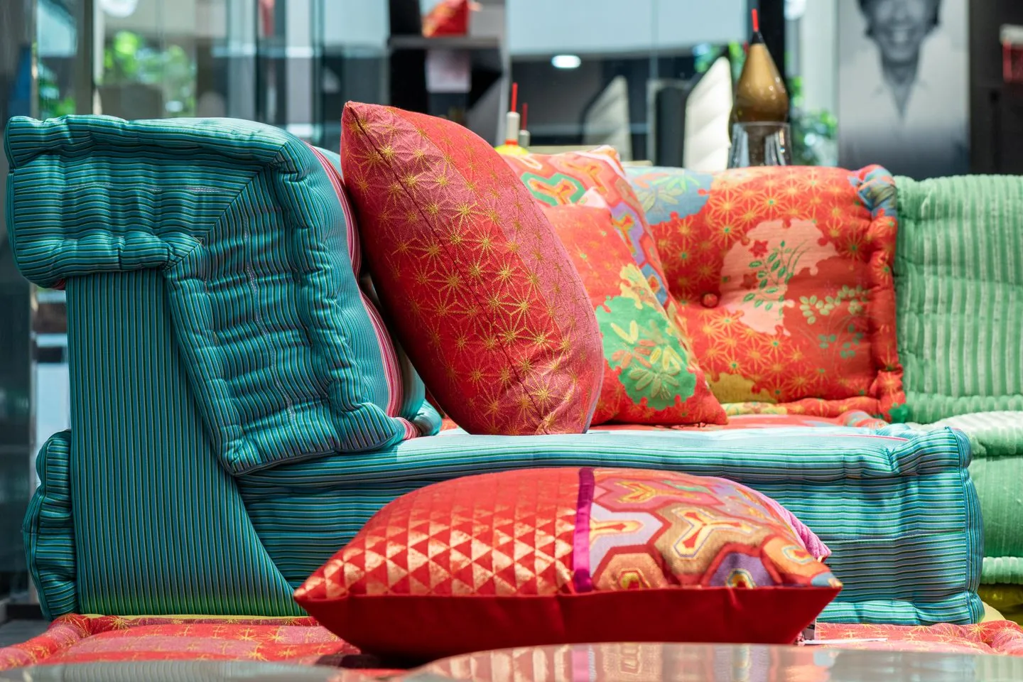 Cushions in contrasting fabrics and patterns on a sofa